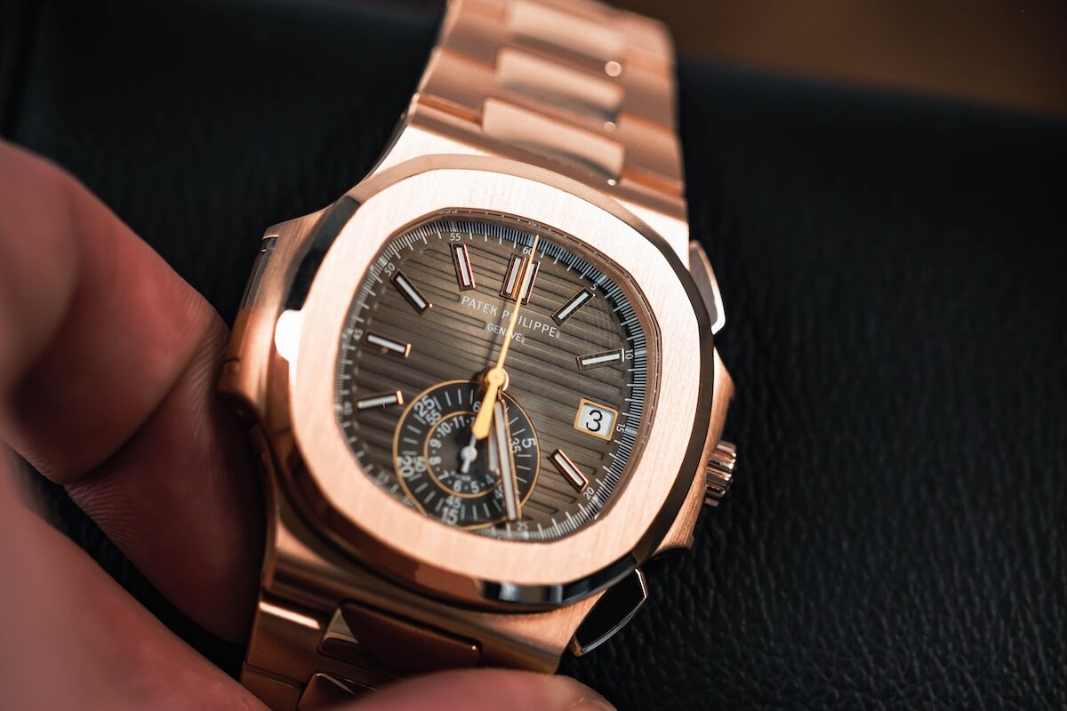 A rose gold Patek Philippe Nautilus held in hand